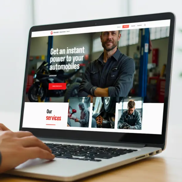 A mechanic stands proudly in a garage bay, looking at the camera, with the website banner reading: "Get an instant power to your automobiles." Below the fold is a section titled "Our services.